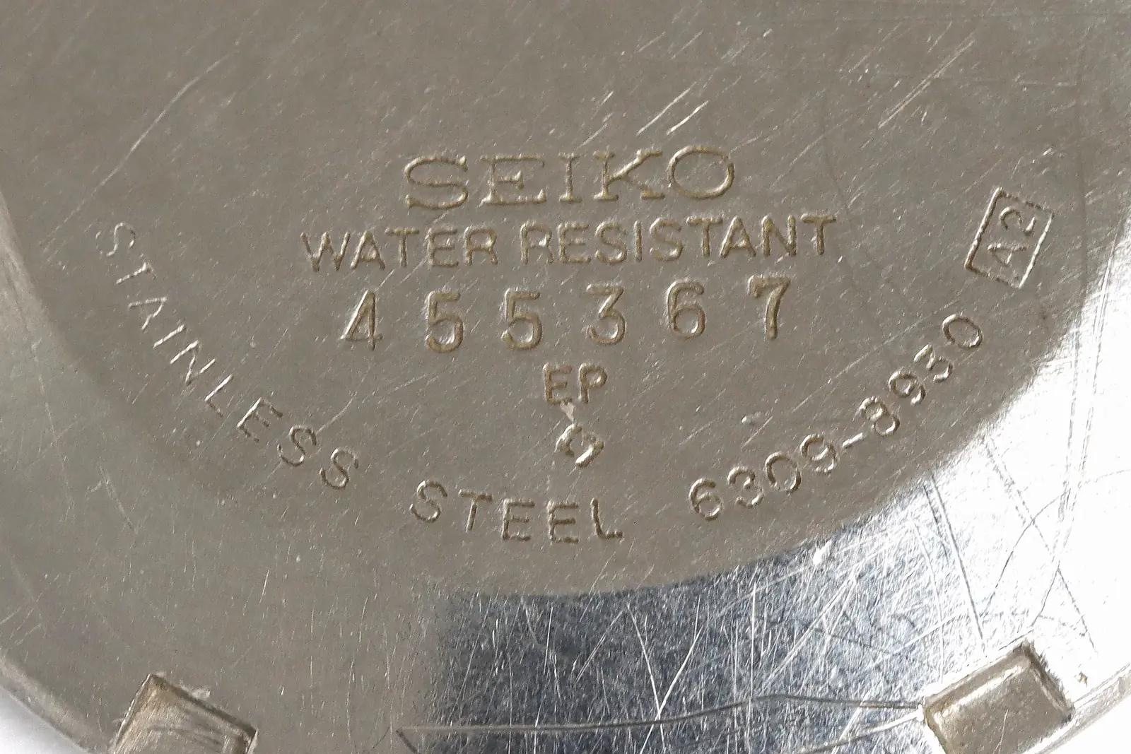 The back of a Seiko 6309 watch, stamped with 6309-8930 and the serial number 455367